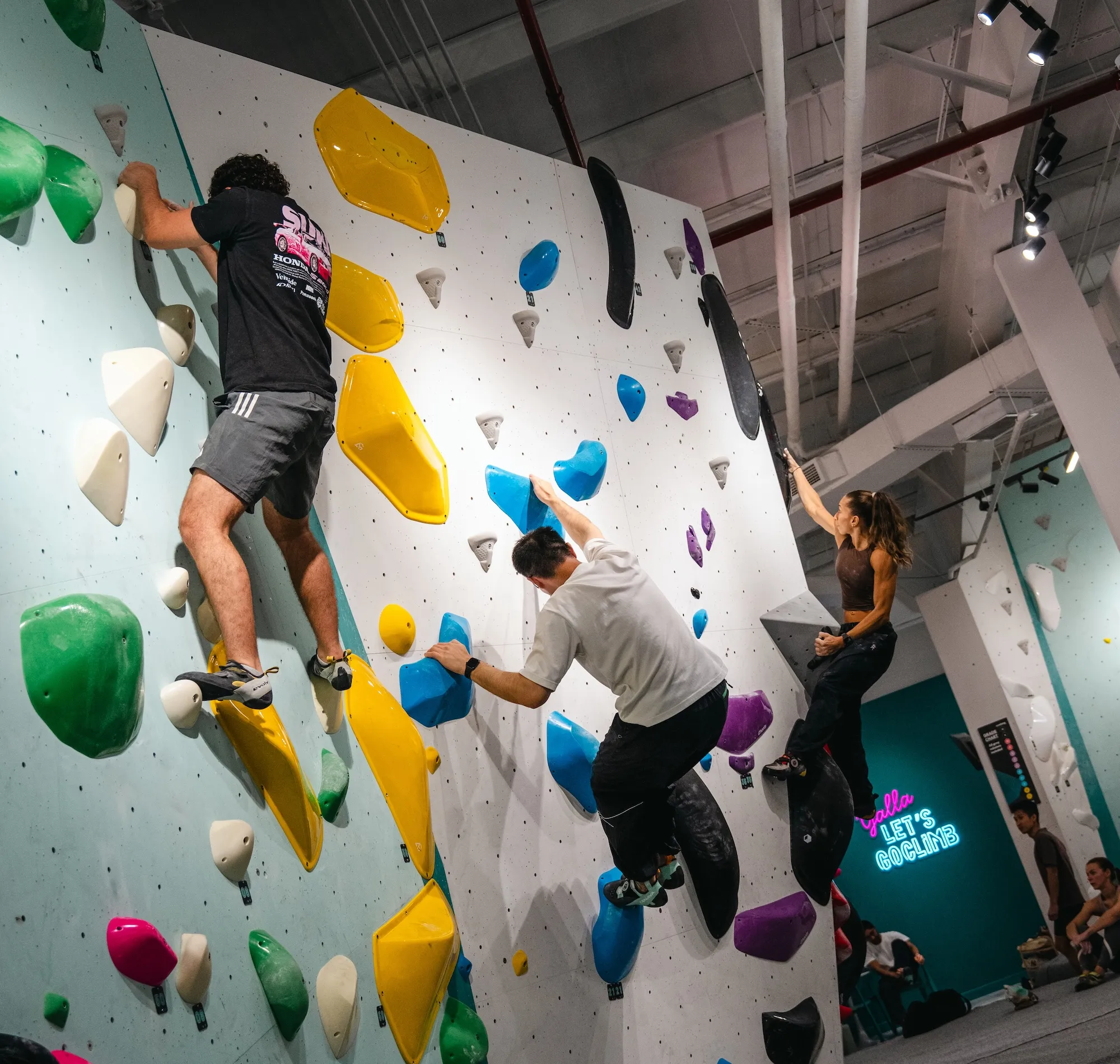Climbers on a boulder problem at GoClimb's 1st Anniversary