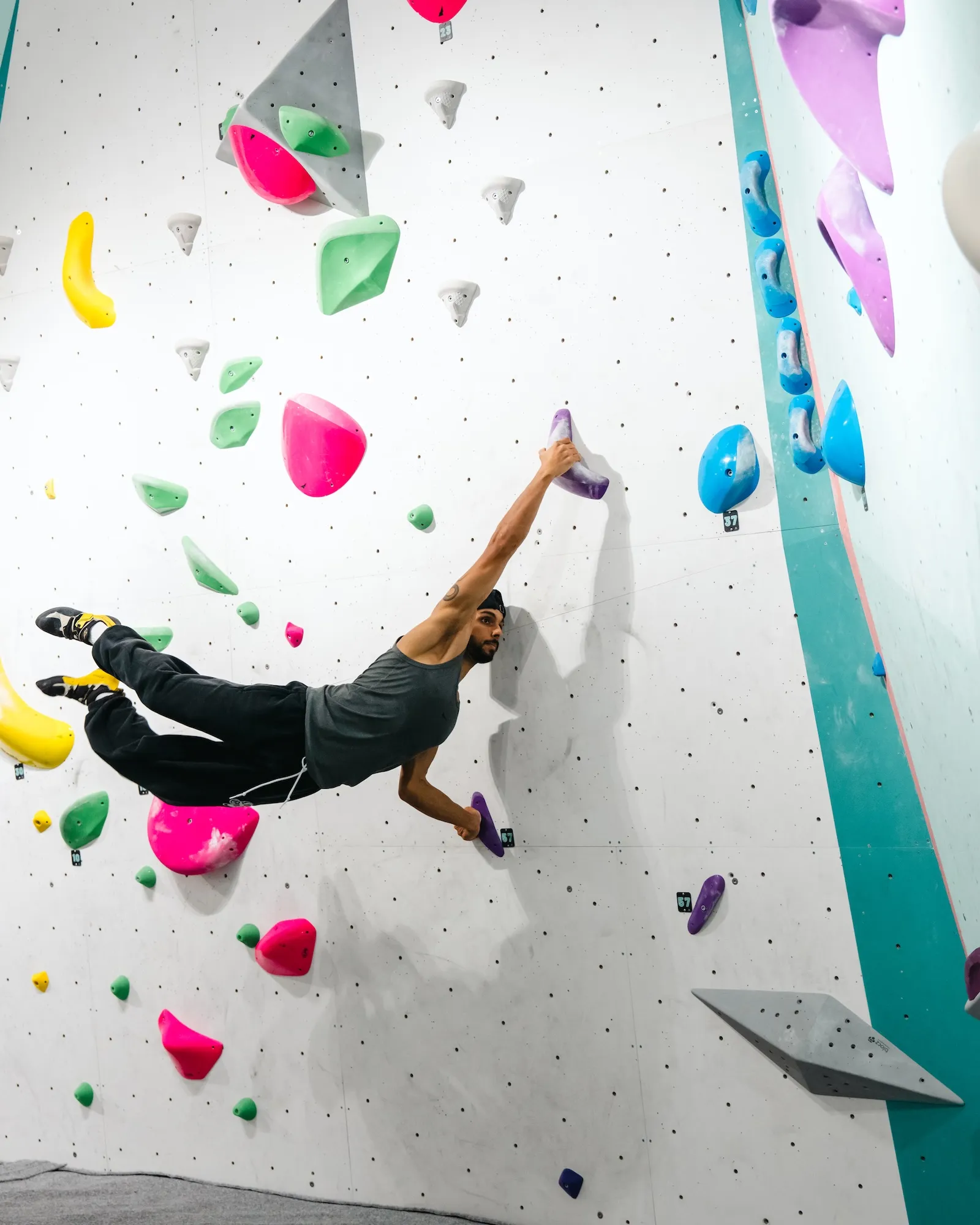 Climber mid-dyno on a boulder problem