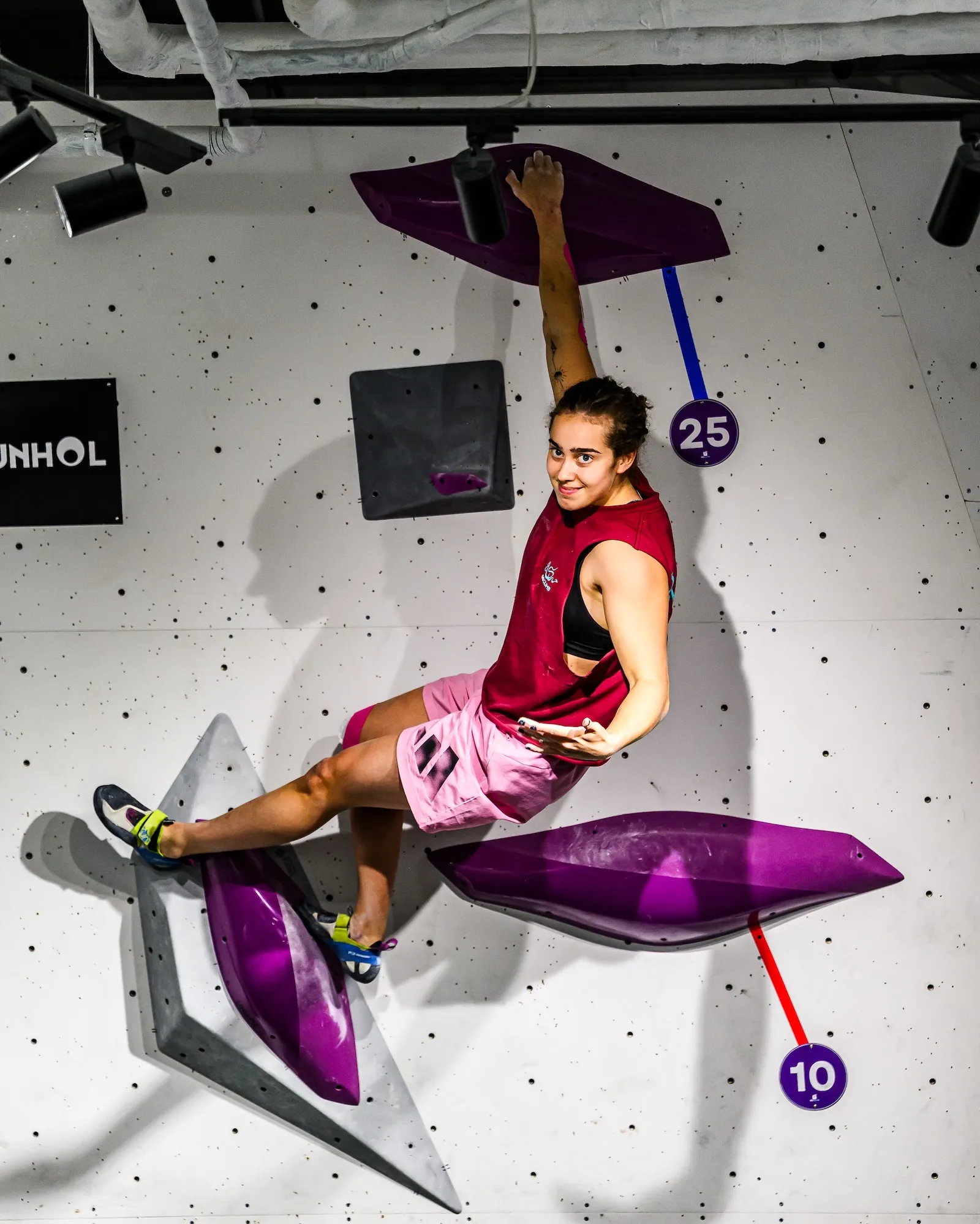 A competitor cutting loose from purple volumes, shot from the mats below